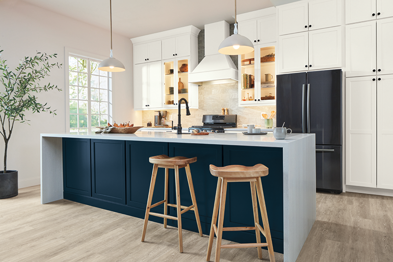 A kitchen island with bar chairs that is a space for cooking and dining.