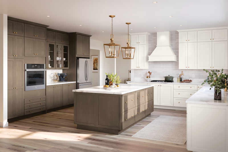 This minimalist kitchen includes a beautiful contrast of taupe-colored cabinets to the left, a center kitchen island which matches the taupe cabinets, and off-white cabinetry to the right. There is a natural-toned sandy rug on the floor, marble countertops, and brass chandeliers above the island. 