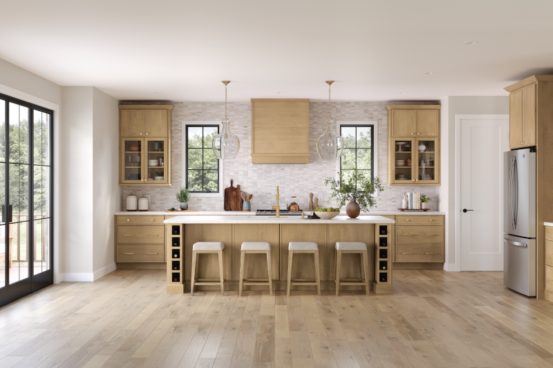 A kitchen with wood-toned cabinets and island and white walls.