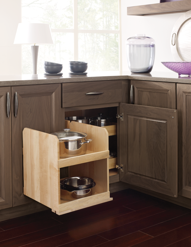 A swing-out corner kitchen cabinet storing kitchen appliances and dishware.