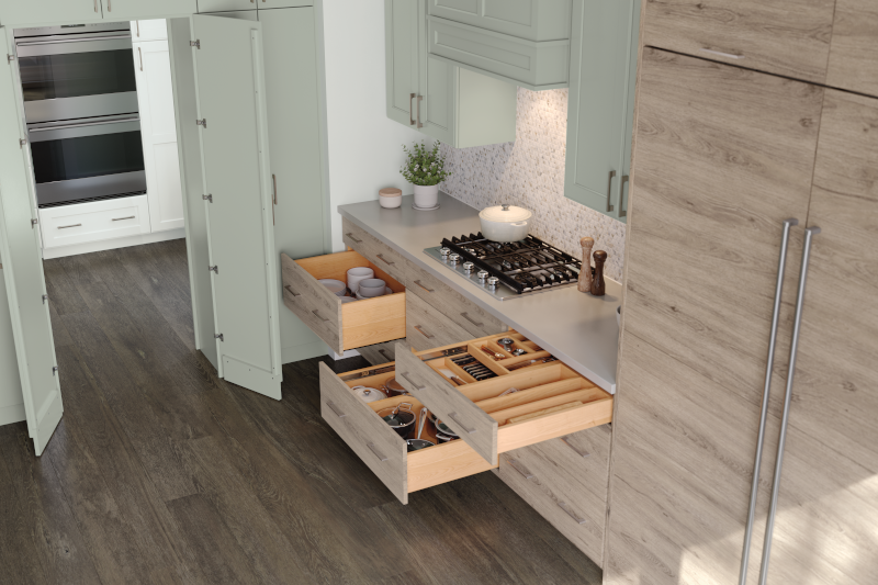 A kitchen with cabinets that feature an integrated refrigerator and cutlery dividers in drawers. 