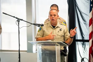 officers speaking at a podium