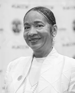 Woman smiling for a photo in black and white.