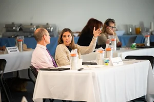 a group of people sitting at tables at an event