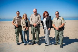 a group of people in front of the beach