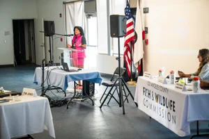 a woman speaking at a podium