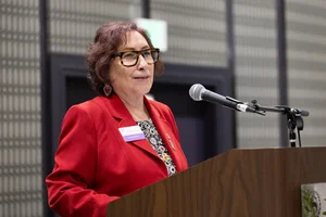 a woman speaking at the podium