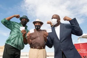 District 2 – Supervisor Holly J Mitchell March 24, 2021 - Arsenio Hall, Danny Trejo, and Earvin Magic Johnson show off their COVID-19 vaccination cards after getting their first dose at USC. Photo by Bryan Chan / Board of Supervisors