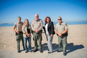 a group of people in front of the beach
