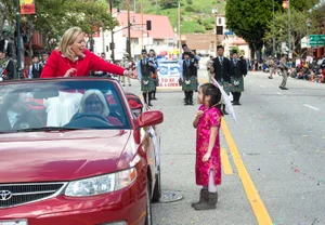 Supervisor Barger waving to a young girl from the car at the "Chinese New Year Parade"