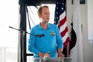 a man speaking at the podium at the event