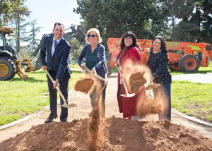 Supervisor Hahn scooping dirt at the Adventure Park Ground Breaker