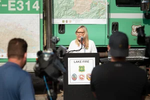 Supervisor Barger speaking into a microphone at the "Lake Fire Press Conference"