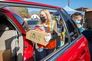 Supervisor Barger handing out boxes of food at the "Day of Giving Altadena"