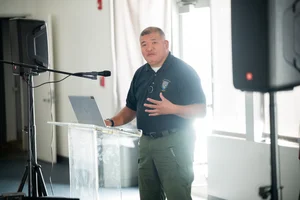 a man speaking at the podium at the event