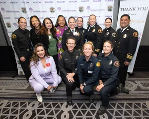 a group photo of 10+ people smiling together.