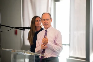 a man speaking at the podium at the event