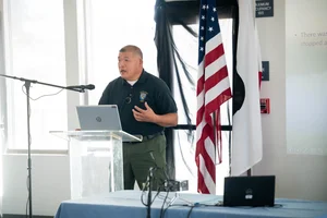 a man speaking at the podium at the event