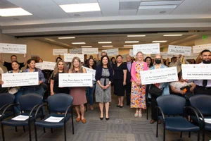 Supervisor Solis group photo with other's holding checks up
