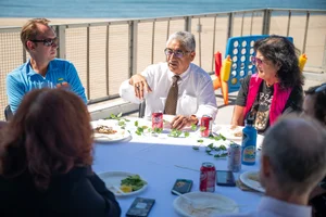 a group of people sitting at a table outside