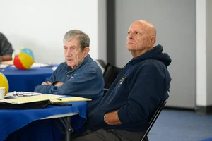 2 men sitting at a table.