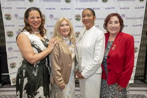4 women posing for a picture.