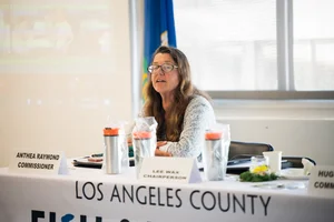 Commissioner sitting at a table at an event.