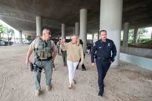 Supervisor Barger speaking to an officer and military man