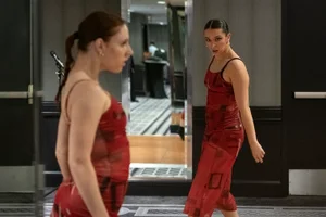 2 women in red dresses.