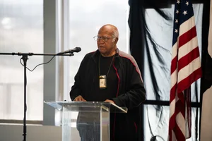 a man speaking at a podium at an event