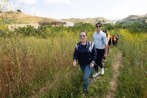 Supervisor Horvath walking through meadows in a group