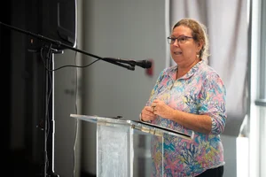a woman speaking at a podium