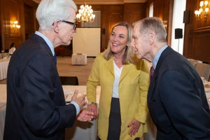 Supervisor Barger speaking to two men at an event