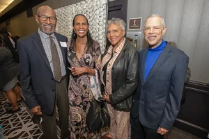 4 people posing for a photo together.