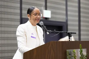 a woman speaking at the podium