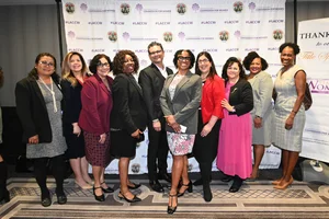 a group photo of people smiling.