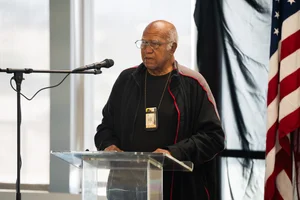 a man speaking at a podium at an event.