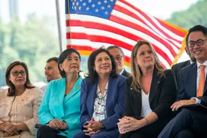 Supervisor Solis group photo in front of an American flag