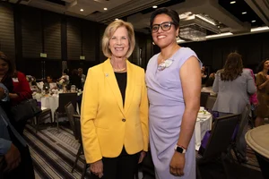 Supervisor Hahn smiling for a photo with another woman.