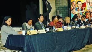 Group photo of people sitting at a table/panel.