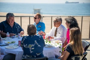 a group of people sitting at a table outside