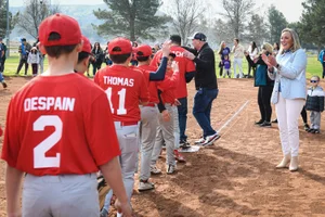 Supervisor Barger clapping for young boys' baseball team walking by