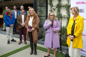 Supervisor Horvath speaking at an event with Supervisor Barger and Supervisor Hahn next to her
