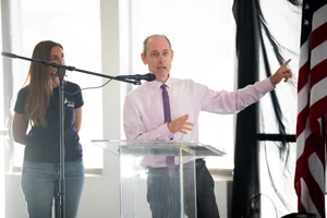 a man speaking at the podium at the event