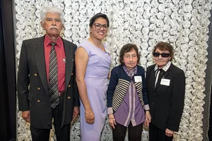 4 people posing together for a photo.