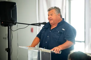 a man speaking at the podium at the event