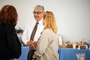 3 people speaking to each other at event