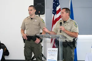 2 officers speaking at the podium