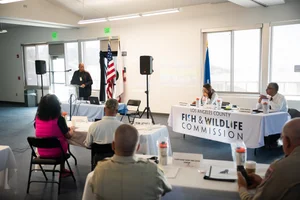 a group of people sitting at tables at an event.