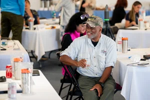 people sitting at tables at an event